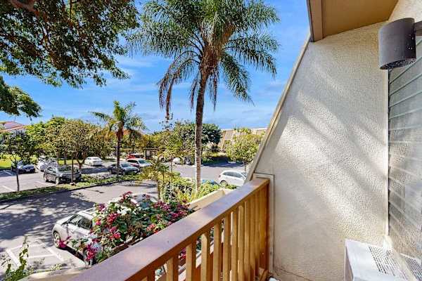 Balcony View Overlooking Parking Area and Tropical Landscaping