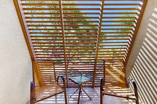 Private Sunlit Balcony Seating Nook with Slatted Wooden Pergola
