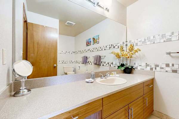 Spacious Vanity Area with Large Mirror and Ample Cabinet Storage