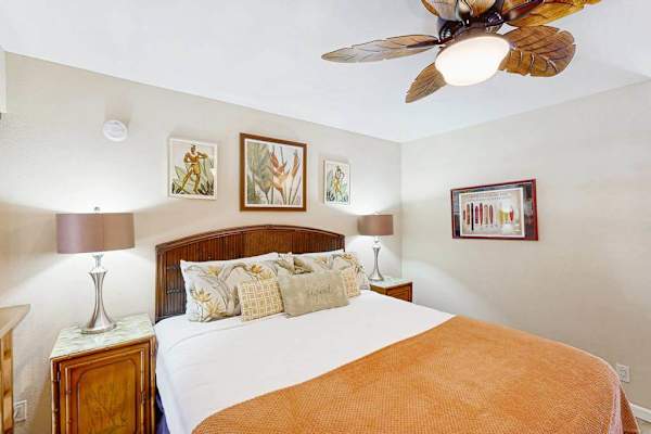 Well-Appointed loft Bedroom featuring Woven Headboard Bed, Nightstands, and Ceiling Fan