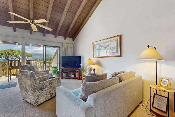 Living room seating frames garden views beneath wood ceiling beams