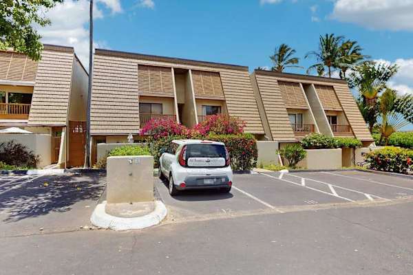 Exterior building entrance offers convenient parking beside landscaped resort grounds