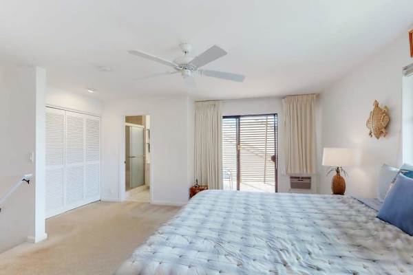 Loft King suite with a ceiling fan, television and balcony access