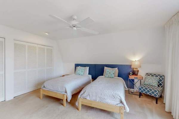 Includes twin beds, seating, and a ceiling fan