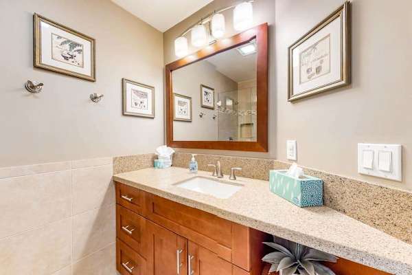 Tidy bathroom vanity offers practical comfort with bright tropical styling