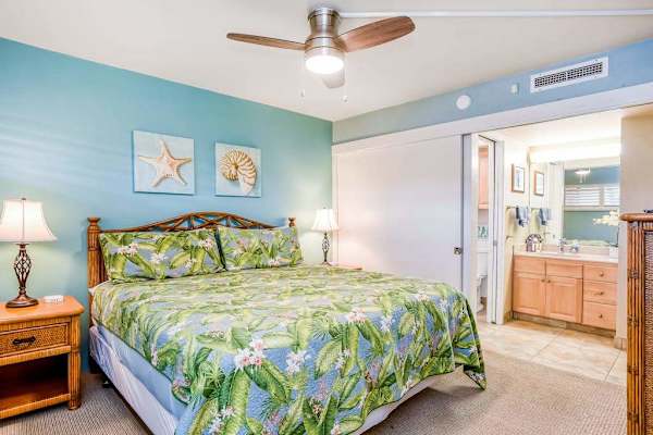 Master bedroom with king bed, ceiling fan, flat screen tv and en-suite bathroom