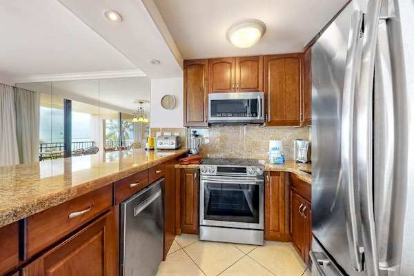 This newly remodeled kitchen with stainless steel appliances.  Large kitchen countertop for all the chef's prep needs and open to the dining room so that you are always with your company.