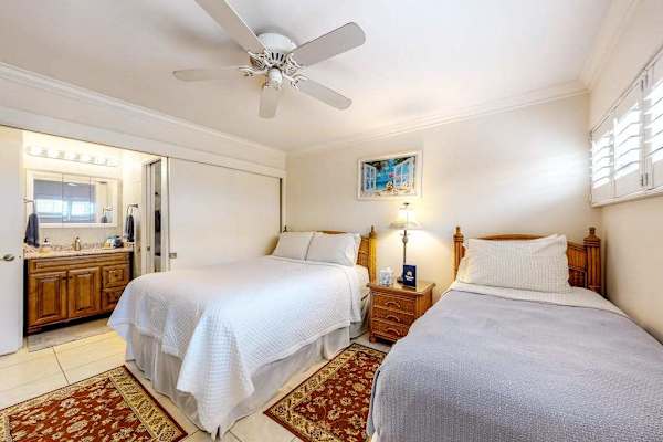 Guest room with queen and single bed with en-suite bathroom.