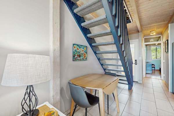 Dining nook beneath staircase provides a cozy setting for meals