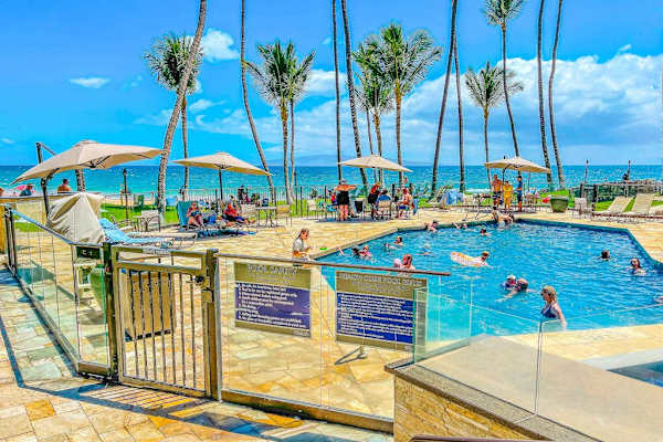 Relax poolside surrounded by tropical landscaping