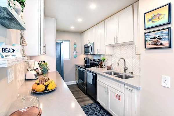 Modern stainless steel kitchen with an open-concept design that flows seamlessly into the living room, making it easy to cook, gather, and stay connected.