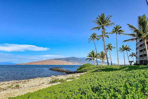 Crystal-clear turquoise waters gently wash onto pristine white sandy beaches.