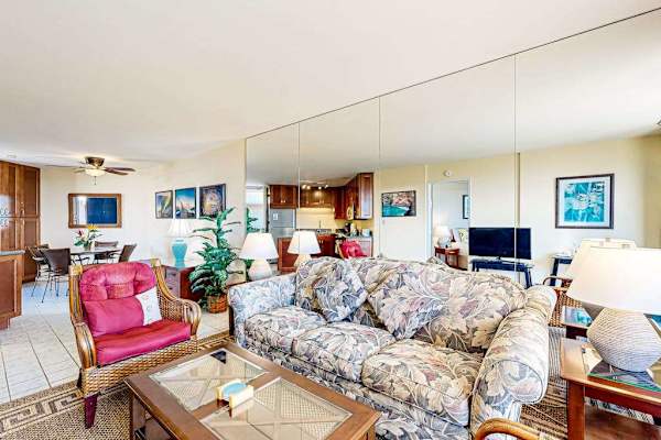 Spacious Living Area with Mirrored Wall & Tropical Decor