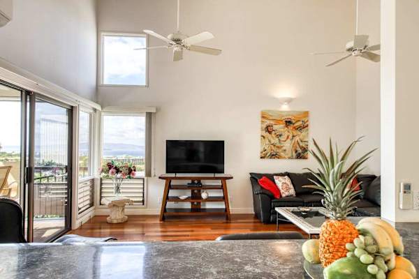 Open-Concept Living Area featuring High Ceilings, TV Unit, and Sliding Patio Doors