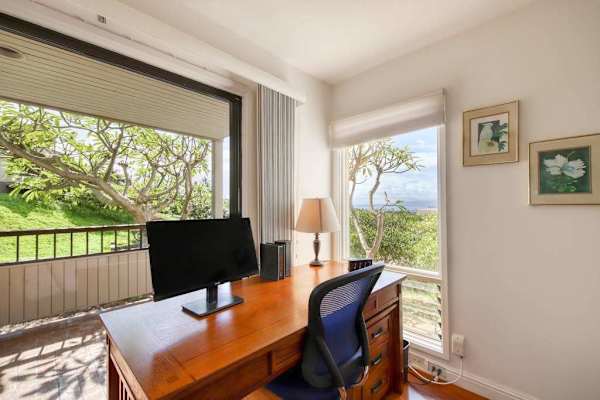Dedicated Workspace with Wooden Desk, Monitor, and Scenic Window Views