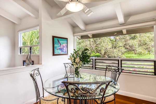 Sunlit Glass Dining Table Set Beside Bright Windows with Garden Views