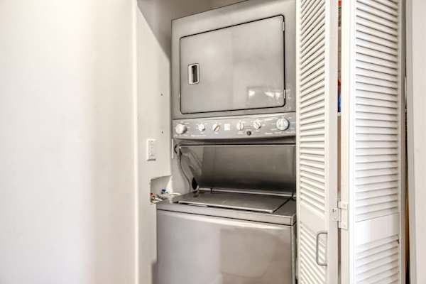 Stacked Washer and Dryer Unit Tucked into Closet Space