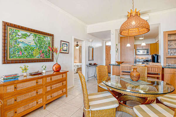Open concept dining with seating for four at the table and two at the breakfast bar