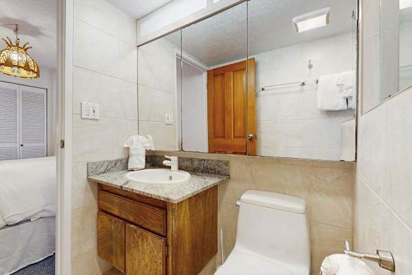The full bathroom offers a spacious vanity and all the essentials for your stay.

