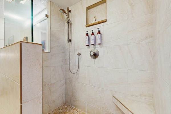 Refresh in the full bathroom featuring a walk-in shower and modern finishes.