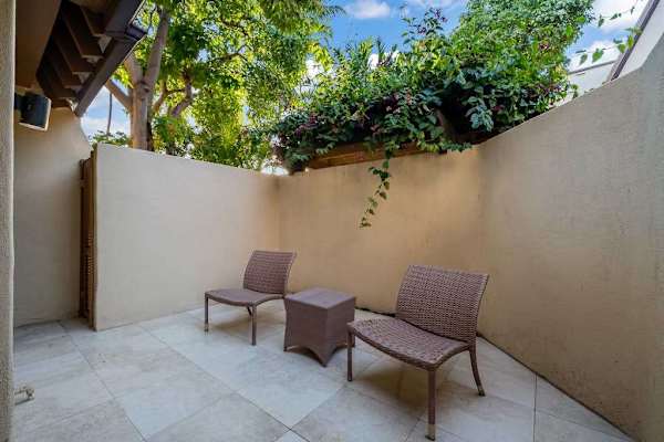Lanai seating invites relaxed mornings surrounded by vibrant tropical gardens