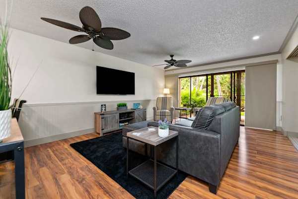 Comfortable living room features sectional sofa television and patio access