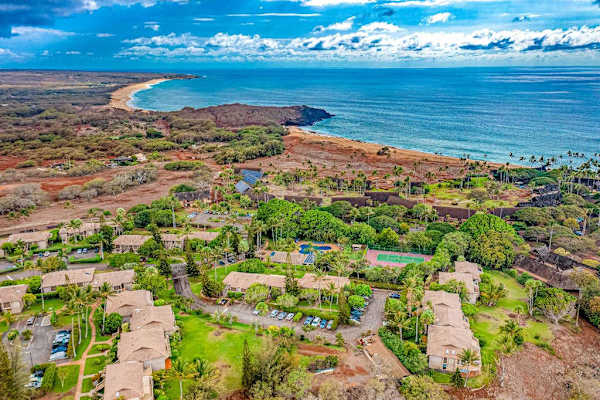 Nearby Molokai shoreline reveals turquoise ocean and rugged volcanic terrain