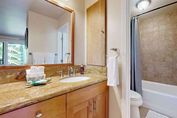 Full Bathroom Featuring Granite Vanity, Large Mirror, and Shower/Tub Combo