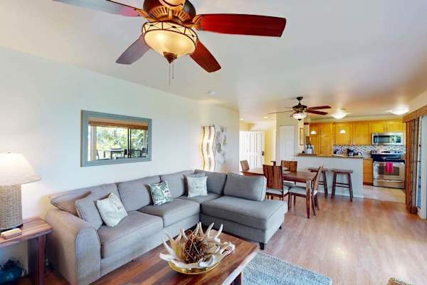Comfortable Living Area Featuring Sectional Sofa, Coffee Table, and Kitchen View