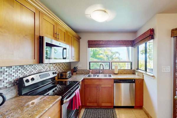 Modern Kitchen with Natural Wood Cabinets, Mosaic Backsplash, and Dishwasher