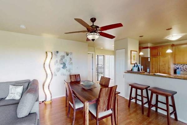 Open-Concept Dining and Kitchen Area with Solid Wood Table and Breakfast Bar