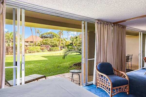 Enjoy direct access to the lush tropical lawn from your garden-view bedroom.