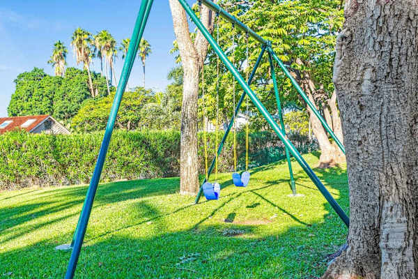 Little ones can enjoy the playground surrounded by lush tropical greenery.