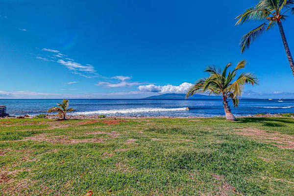 Enjoy peaceful ocean views across the resort's open green space.