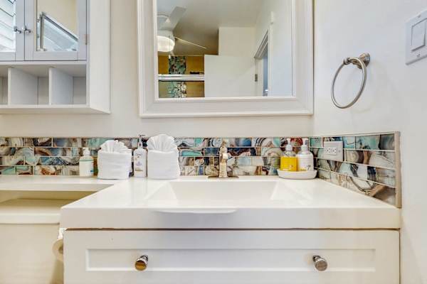 The bright bathroom vanity provides generous counter space for your daily routine.