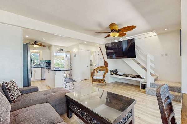 Unwind in the spacious living room with comfortable seating and modern island style.