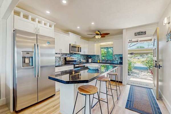 The fully equipped kitchen features modern appliances and a convenient breakfast bar.
