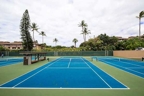 Serve up some fun on the tennis court surrounded by beautiful tropical scenery