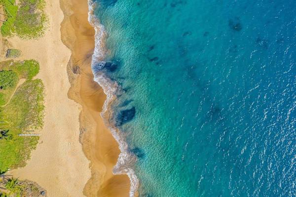 Turquoise Waters And Sandy Shoreline