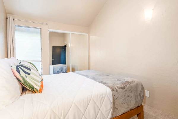 Bright bedroom with views and neutral bedding