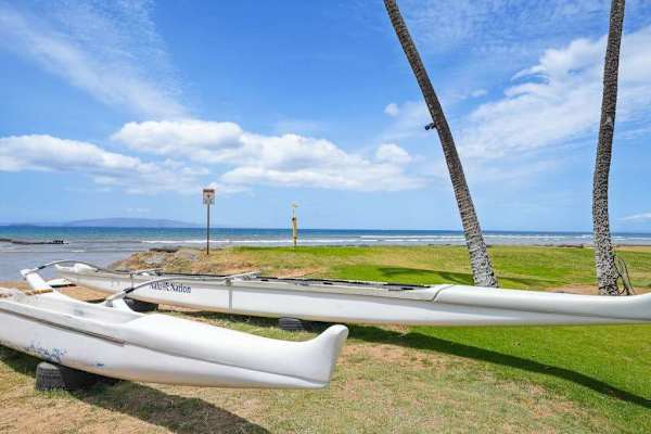 Outrigger canoe resting on the oceanfront lawn