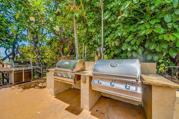 Outdoor Stainless Steel BBQ Grilling Station set amid Tropical Foliage