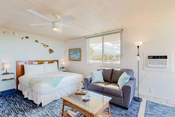 Living area featuring a Queen bed and a dresser with a television.