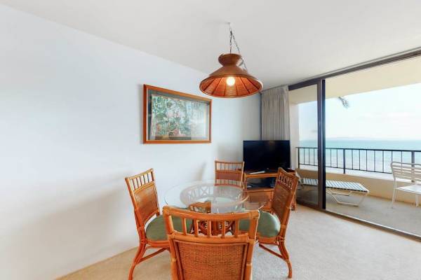 Dining room table with seating for four with views of the ocean through the lanai.