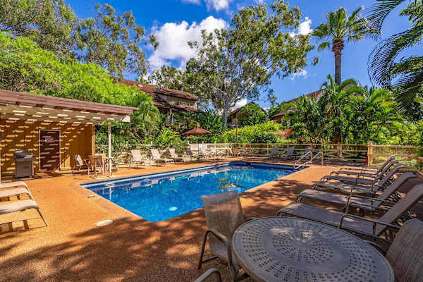 Resort pool offers refreshing swimming surrounded by palms and sunshine