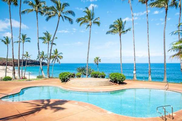 Sunlit resort pool offers refreshing swims with Pacific Ocean views