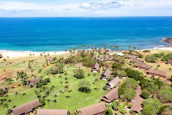 Aerial coastline view shows resort grounds beach and turquoise ocean