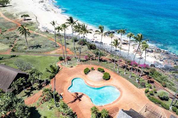 Aerial resort grounds feature lush lawns cottages and Pacific Ocean
