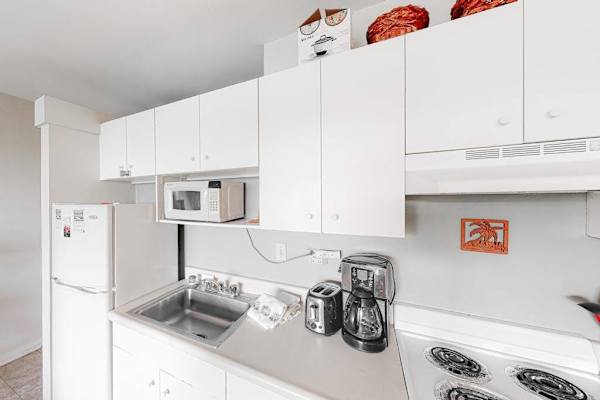 Bright kitchen features appliances countertops and convenient meal preparation space