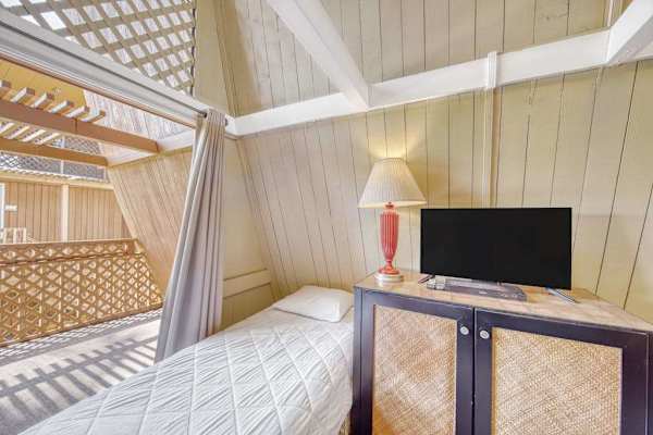 Cozy studio retreat featuring restful bed and TV for laid-back vacation evenings together